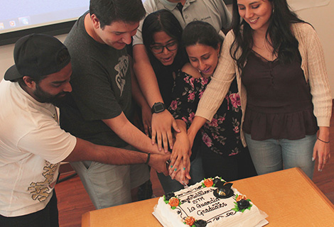 STMs-IDAs-cutting Happy Graduation cake together