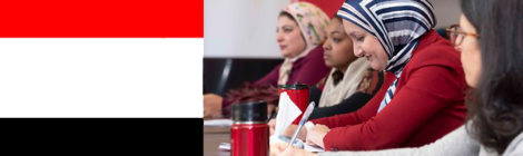 Educators at table; part of Egyptian flag